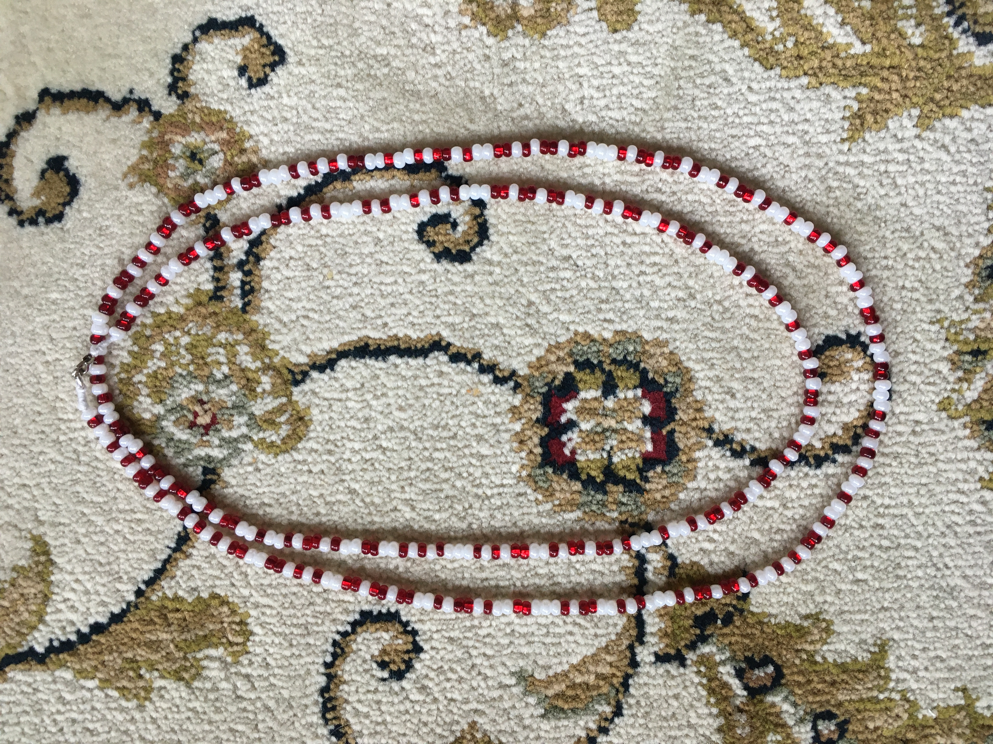 Long necklace with red and white beads