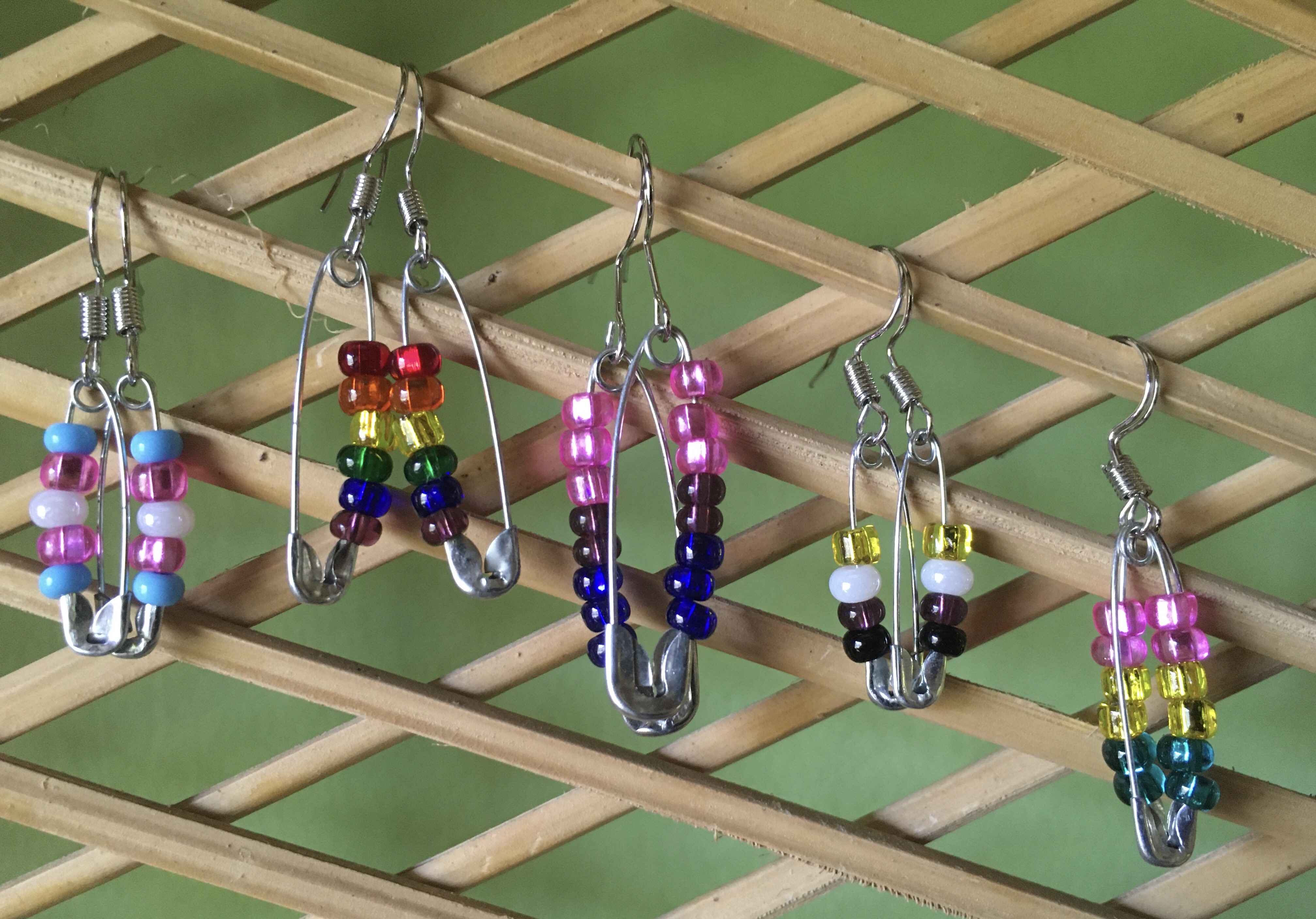 A variety of LGBTQ+ safety pin earrings